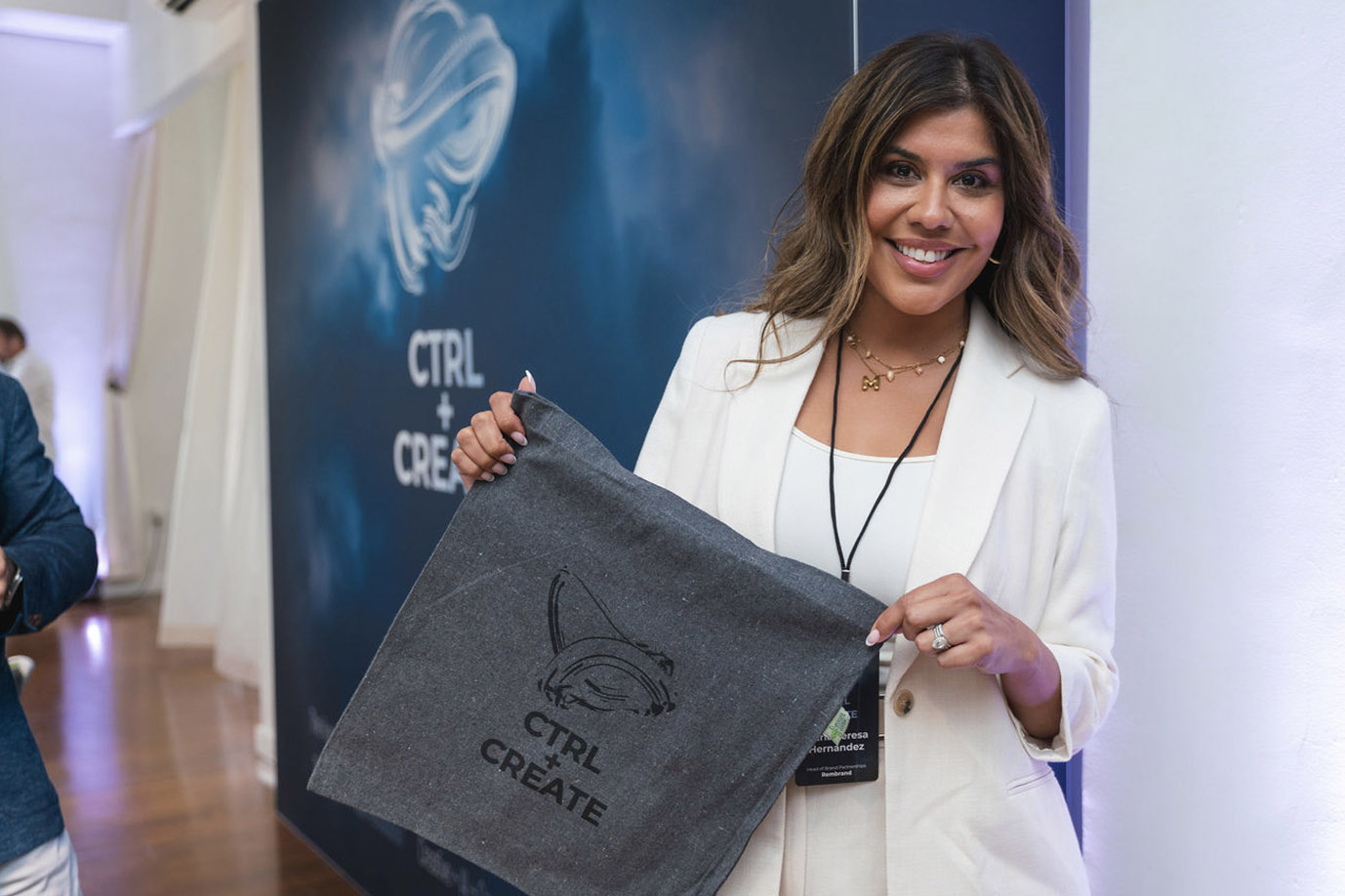 Event attendee holding a branded CTRL Create tote bag